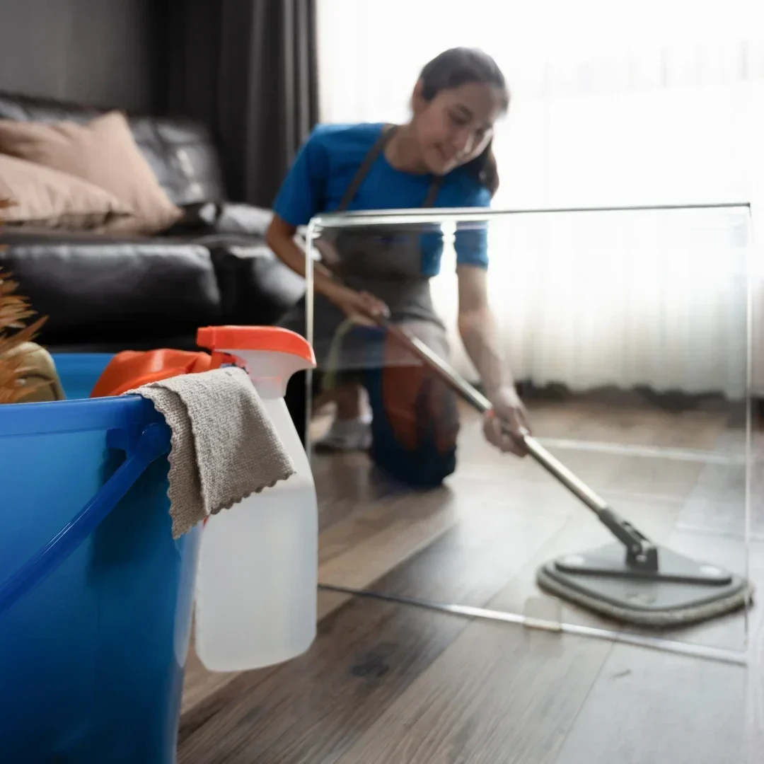 Smiling cleaner cleaning floor in a cozy Fulham home